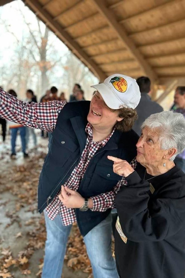 This is a photo of Hillscout founder Will Watson smiling and taking a selfie with an activist at an event.